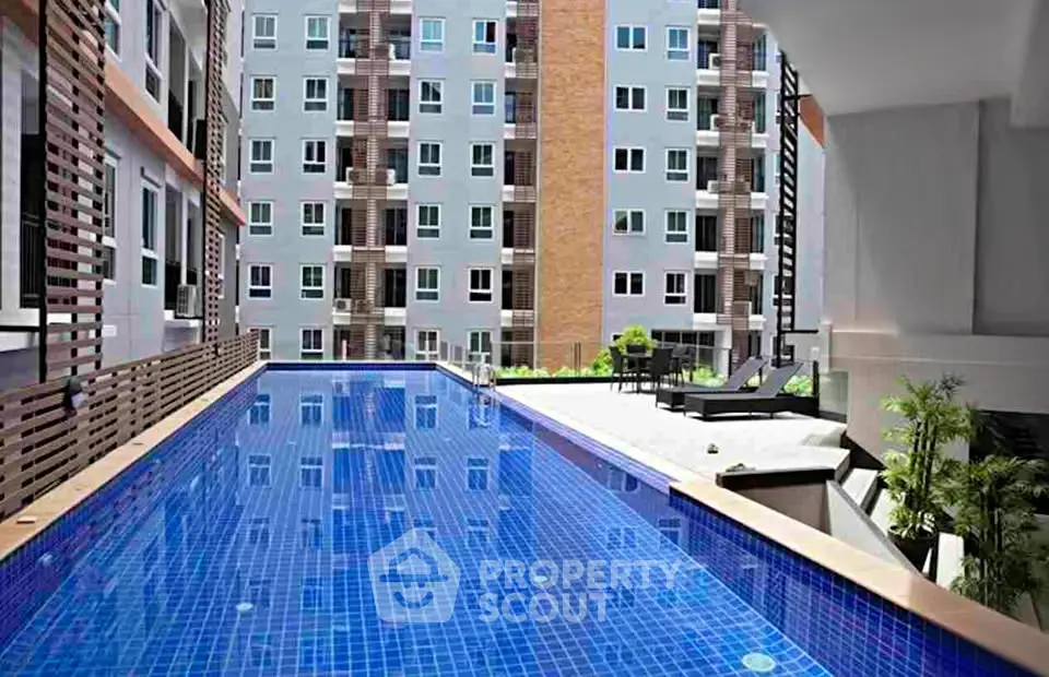 Luxurious apartment complex with stunning outdoor pool and modern architecture.