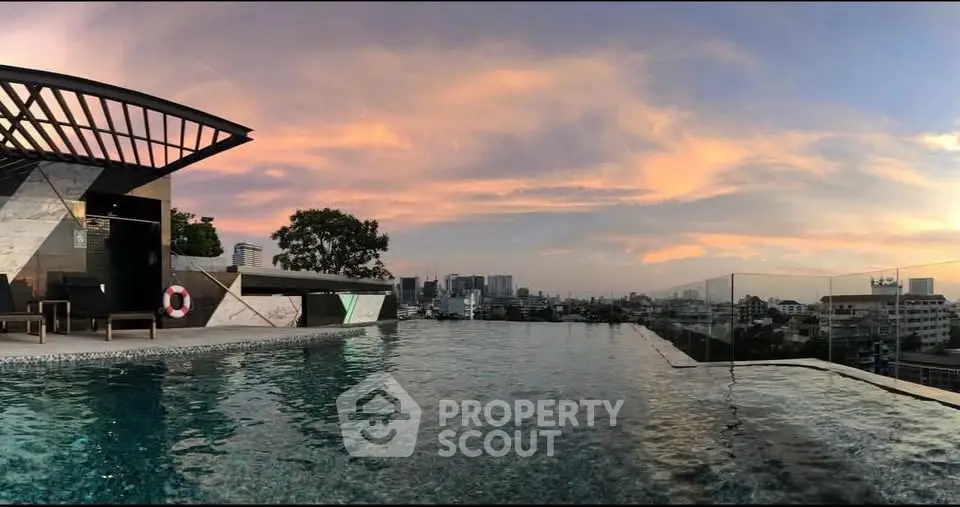 Stunning rooftop infinity pool with panoramic city views at sunset, perfect for luxury living.