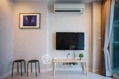 Modern living room with wall-mounted TV and air conditioning unit