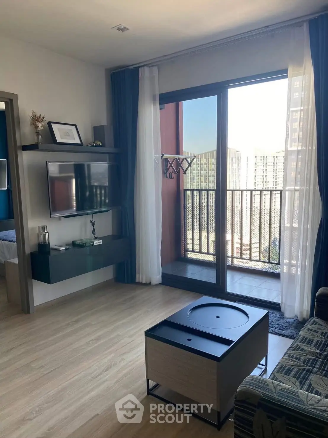 Modern living room with balcony view in high-rise apartment