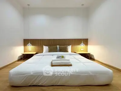 Modern minimalist bedroom with cozy lighting and wooden accents