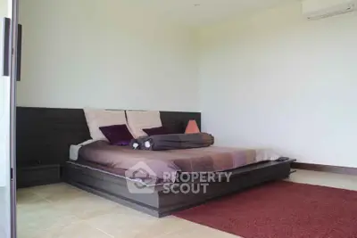 Spacious modern bedroom with stylish platform bed and cozy decor