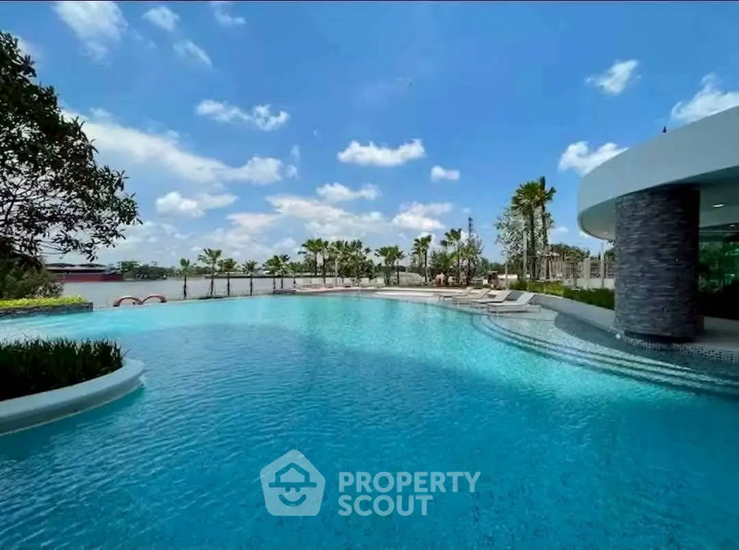 Luxurious resort-style pool with palm trees and serene water views.