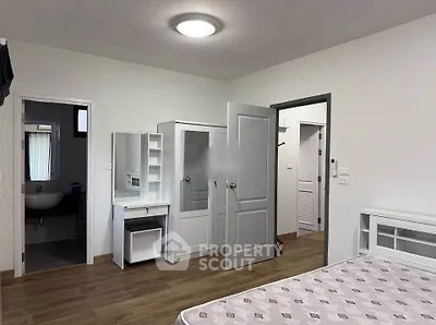 Spacious bedroom with ensuite bathroom and modern furnishings