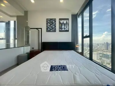 Modern bedroom with stunning city view, large windows, and stylish decor in a high-rise apartment.