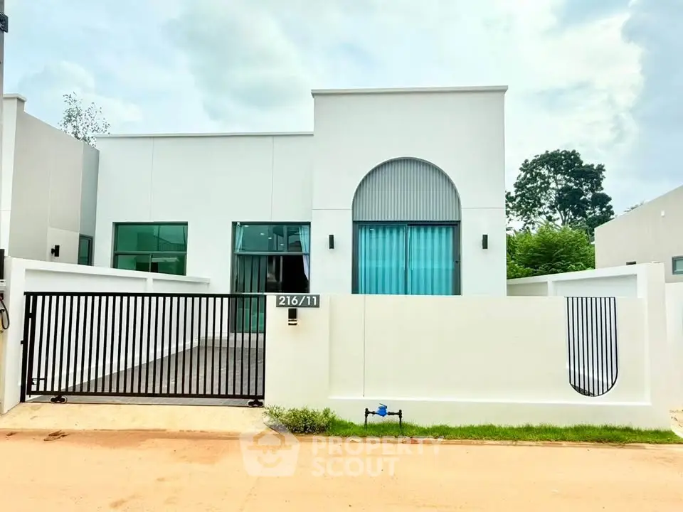 Modern minimalist white house with sleek design and gated entrance
