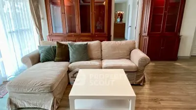 Cozy living room with plush sofa and elegant wooden cabinets