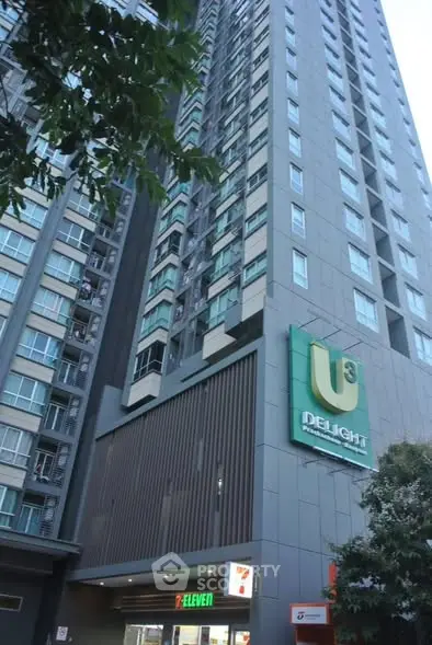Modern high-rise building with sleek design and prominent signage