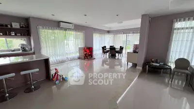 Spacious modern living room with large windows and dining area