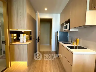 Modern kitchen with sleek cabinetry and built-in appliances in a stylish apartment.