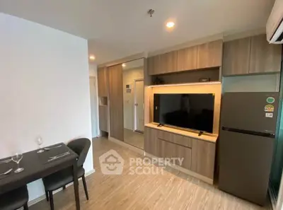 Modern living room with sleek wooden cabinetry and dining area