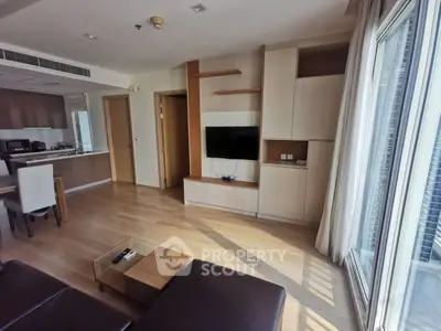 Spacious modern living room with wooden flooring and open kitchen layout