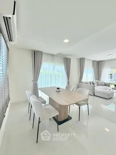 Spacious modern living and dining area with elegant decor and natural light.