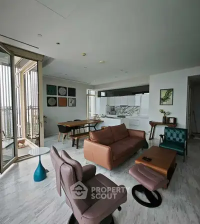 Spacious modern living room with stylish furniture and open layout, featuring a big balcony and elegant decor.