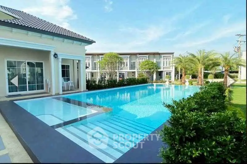 Luxurious villa with stunning pool and lush garden, perfect for relaxation and entertainment.
