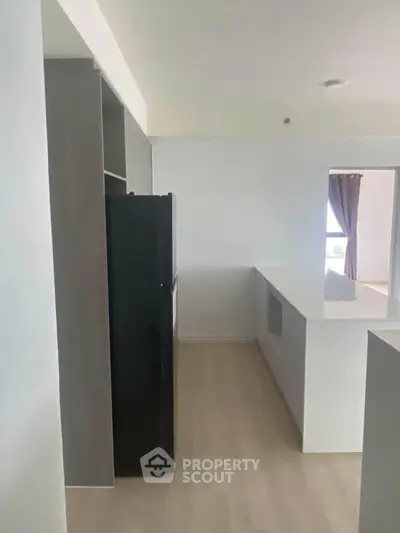 Modern kitchen with sleek design and open layout, featuring a spacious countertop and integrated appliances.