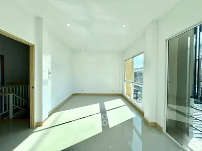 Bright and spacious room with large windows and glossy tiled floor, ideal for modern living.