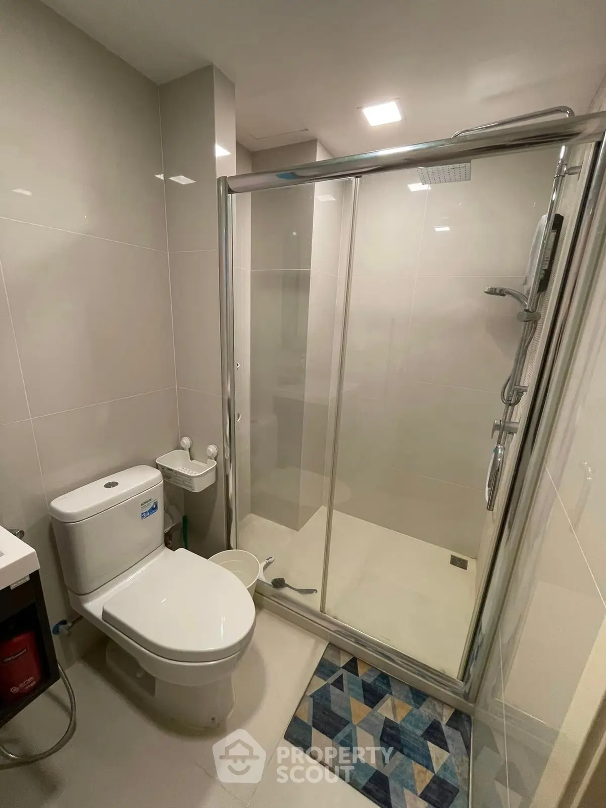 Modern bathroom with glass shower enclosure and sleek fixtures