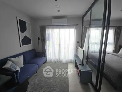 Modern living room with glass partition and cozy blue sofa