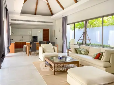 Spacious modern living room with open kitchen and garden view, featuring elegant decor and high ceilings.