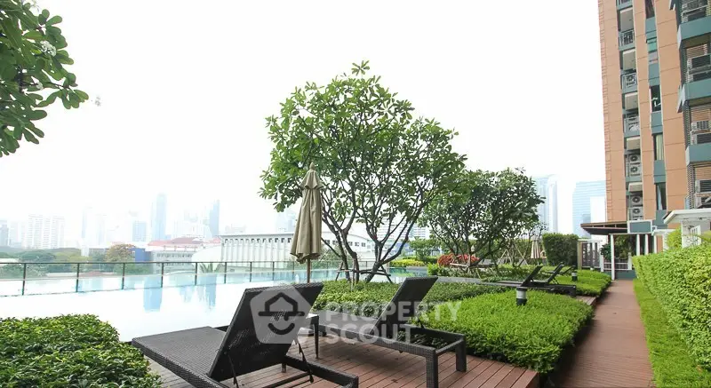 Luxurious rooftop pool with city skyline view and lush greenery, perfect for relaxation and leisure.