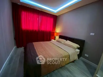 Cozy bedroom with ambient lighting and red curtains for a warm atmosphere.