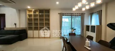 Spacious living room with modern dining area and large windows for natural light.
