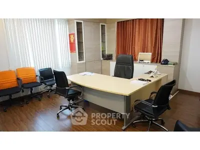 Modern office space with executive desk and chairs, ideal for business meetings.
