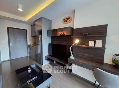 Modern living room with sleek furniture and integrated kitchen area, perfect for urban living.