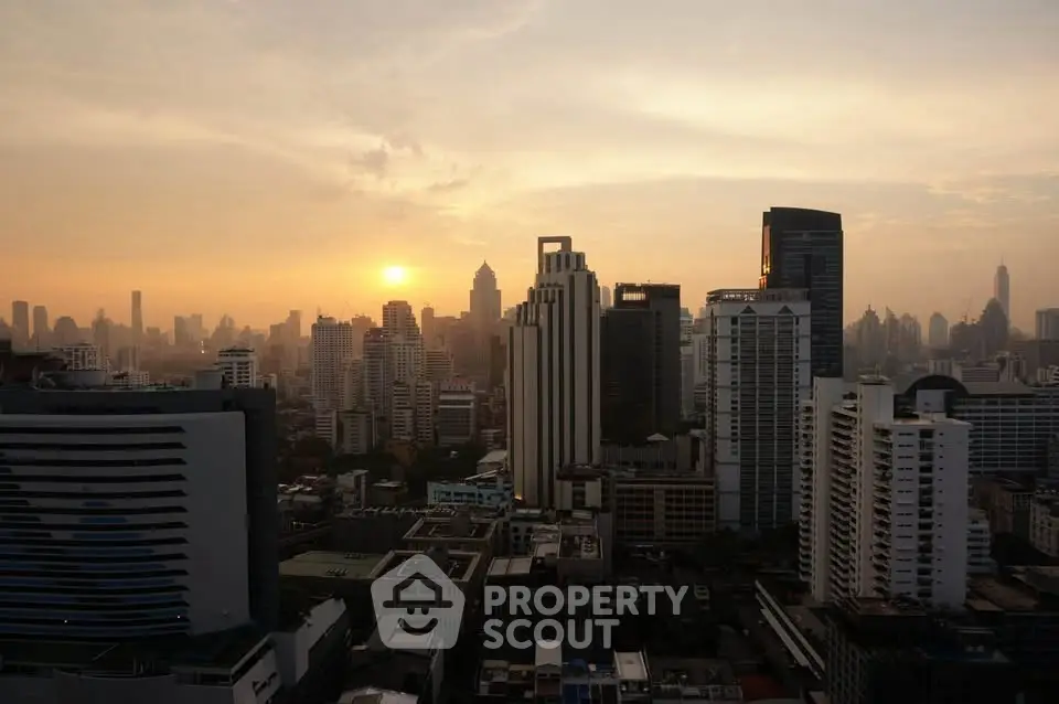 Stunning city skyline view at sunset with high-rise buildings and vibrant sky.