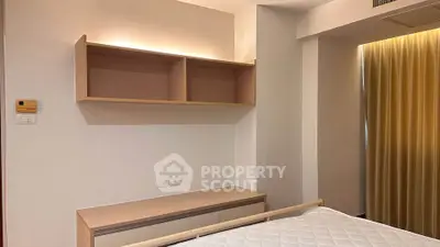 Modern bedroom with built-in shelves and cozy lighting