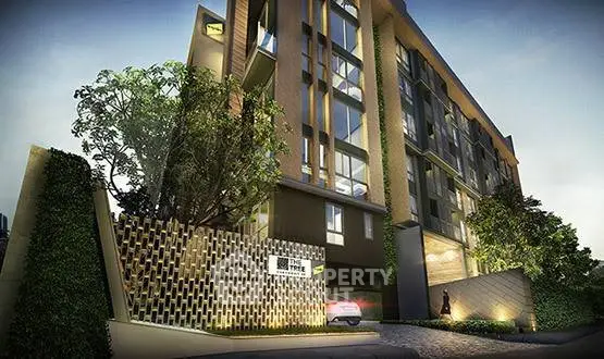 Modern apartment building exterior with lush greenery and stylish architecture.