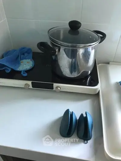 Modern kitchen with induction cooktop and stainless steel pot