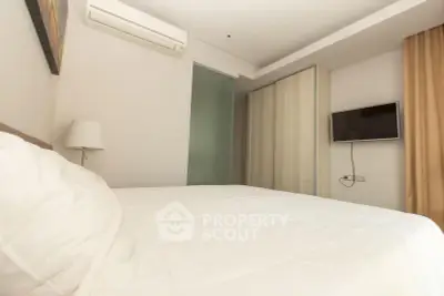 Modern bedroom with sleek design, featuring a wall-mounted TV and air conditioning for comfort.
