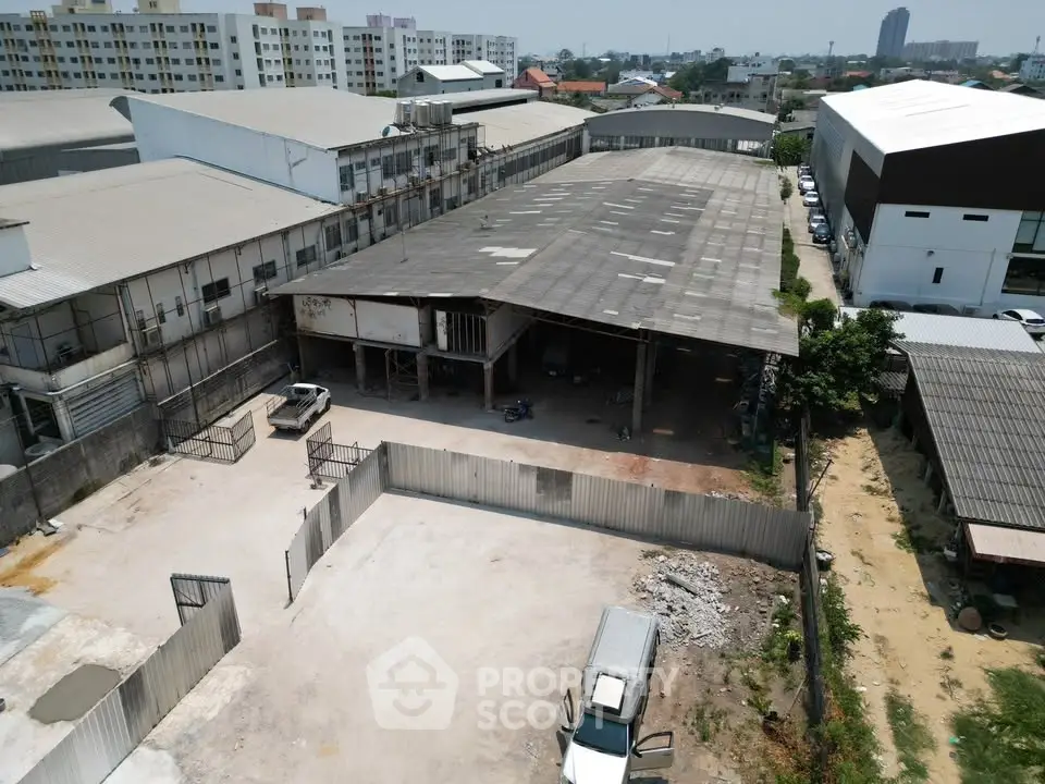 Expansive industrial warehouse with ample outdoor space in urban setting