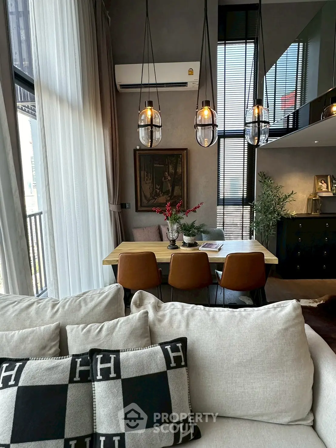 Modern living room with stylish decor and large windows for natural light.