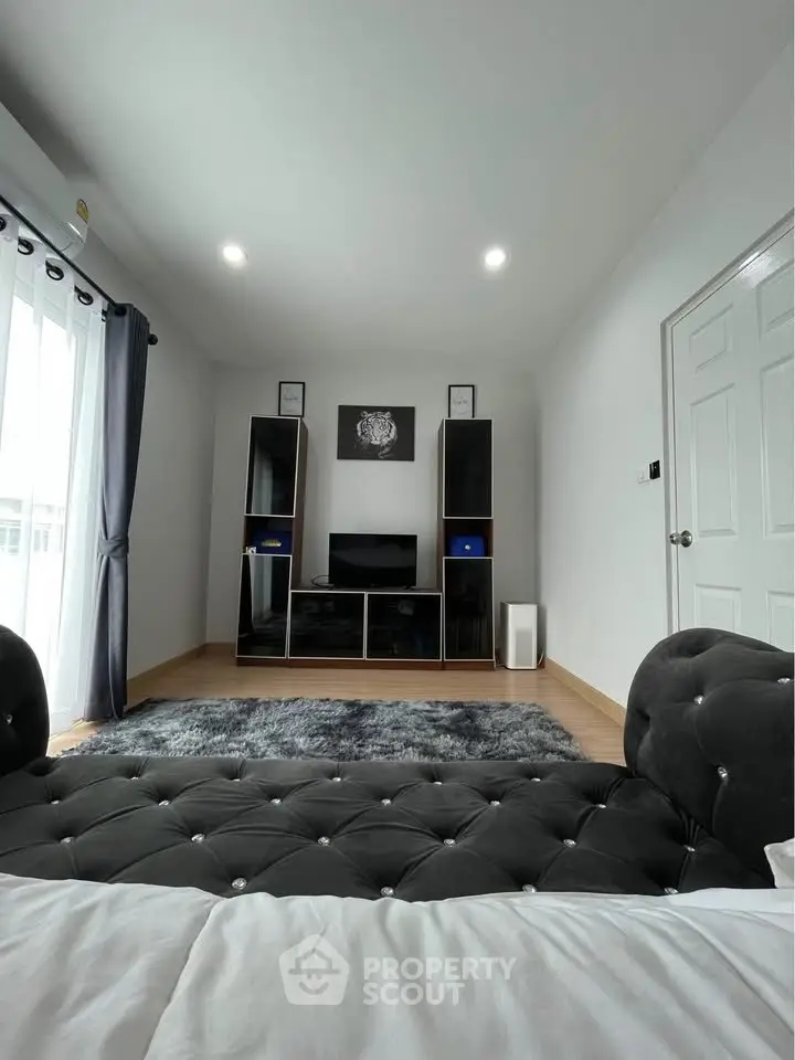 Stylish modern living room with plush sofa and entertainment center