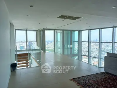 Luxurious high-rise apartment with panoramic city views and spacious open living area.