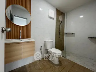 Modern bathroom with sleek fixtures and glass shower enclosure