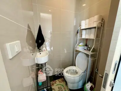 Compact bathroom with modern fixtures and ample storage space.
