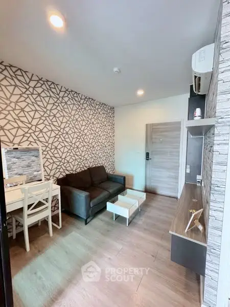 Modern living room with geometric wallpaper and cozy furniture