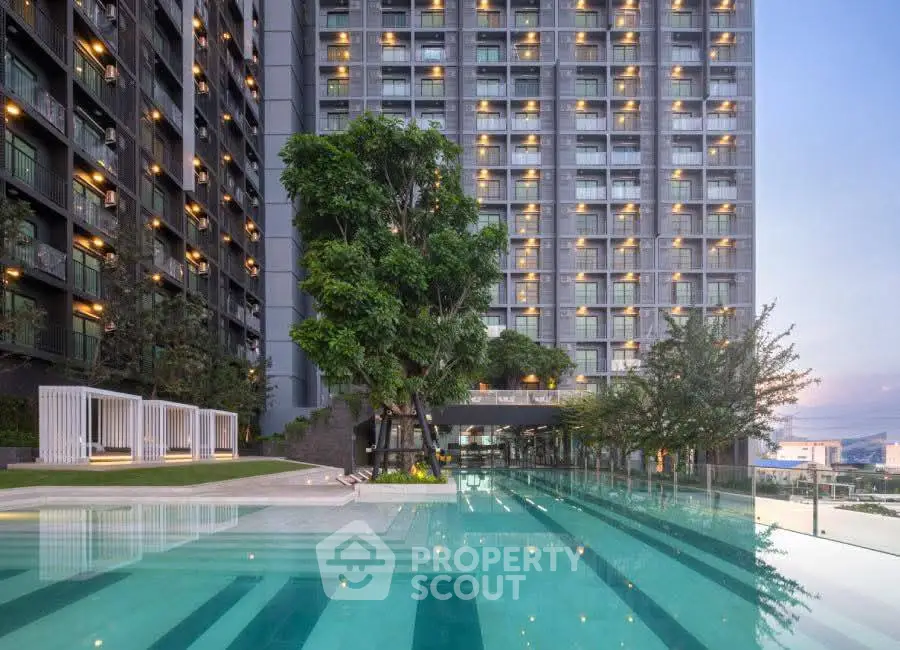 Luxurious high-rise building with stunning pool and lush greenery, perfect for modern urban living.