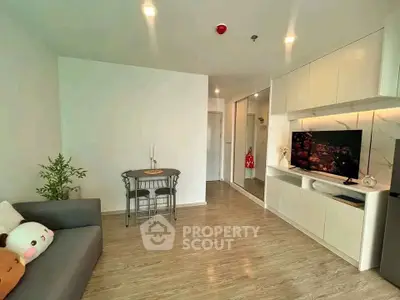 Modern living room with sleek design, featuring a cozy sofa, stylish TV unit, and elegant decor.