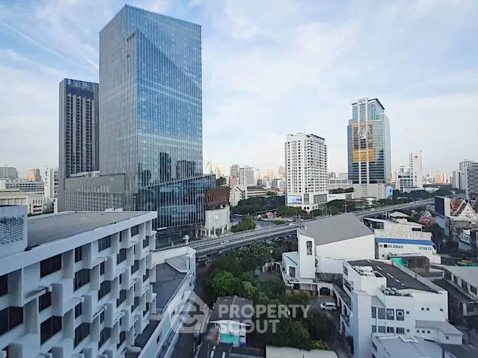 Stunning cityscape view with modern high-rise buildings and clear blue sky.