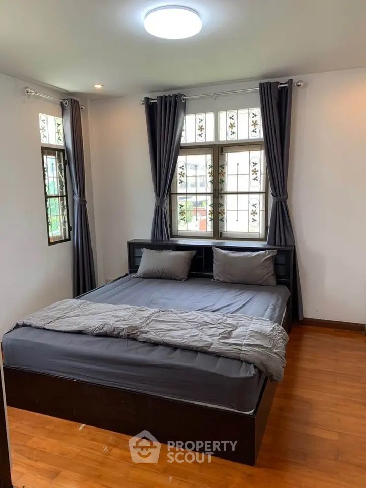 Cozy bedroom with stylish decor and natural light, perfect for relaxation and comfort.