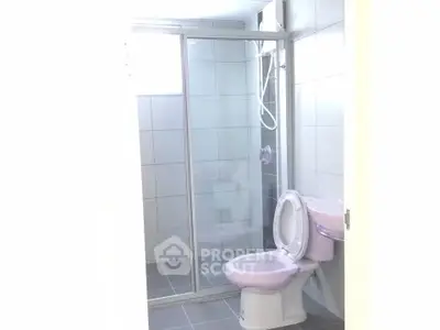 Modern bathroom with glass shower enclosure and tiled walls