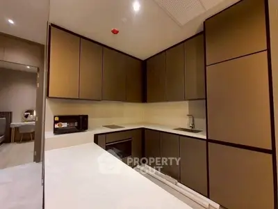 Modern kitchen with sleek cabinetry and built-in appliances in a contemporary apartment.
