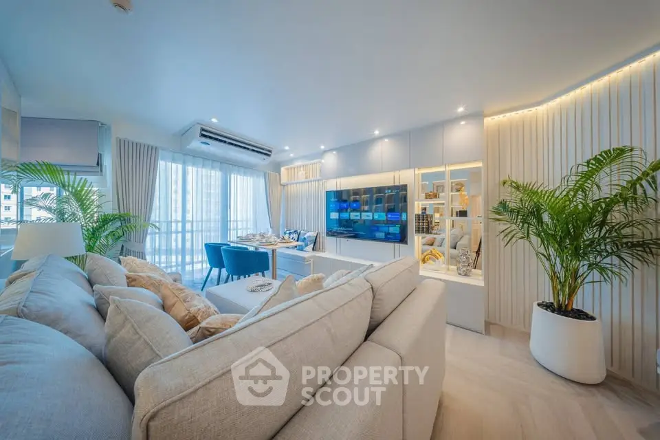 Luxurious modern living room with elegant decor and large windows offering natural light.