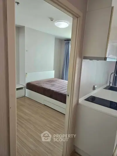 Modern compact apartment with cozy bedroom and sleek kitchen
