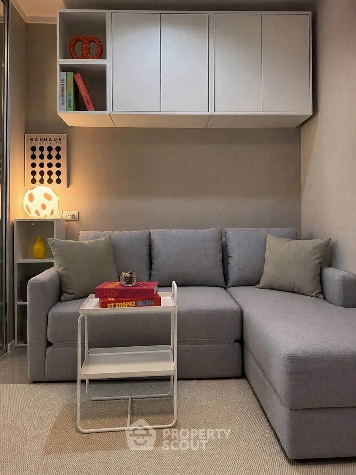 Cozy modern living room with stylish gray sofa and chic decor accents.
